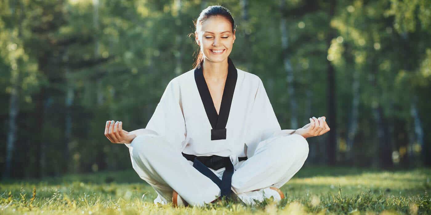 Martial Arts Lessons for Adults in Burlington NJ - Happy Woman Meditated Sitting Background